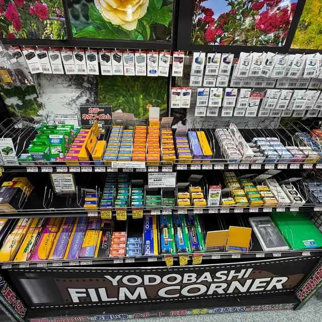 The film corner at a Yodobashi Camera store, shelves of Kodak and Fuji boxes with yen price tags