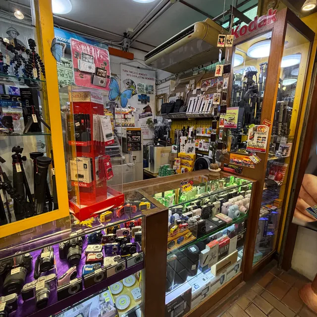 A small camera shop in Kuala Lumpur with glass cabinets full of compact cameras and film