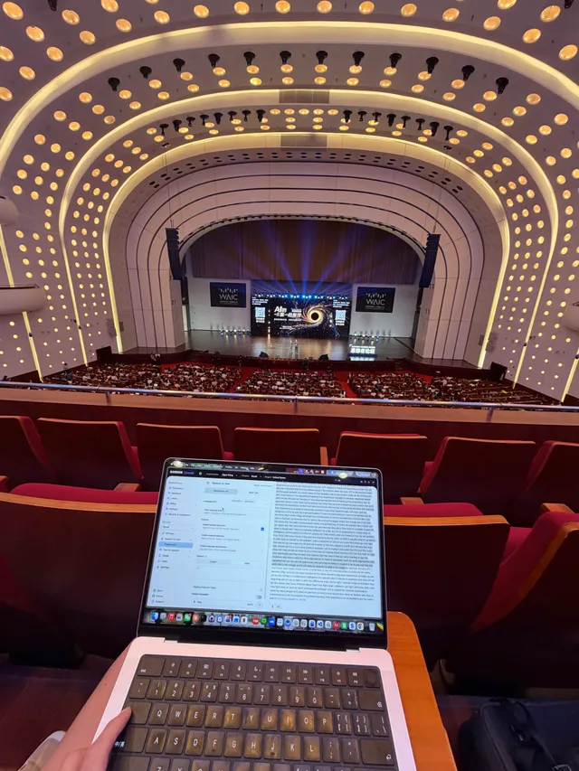The auditorium at WAIC 2026 before Sutton's talk, seen from the balcony with the stage in the distance